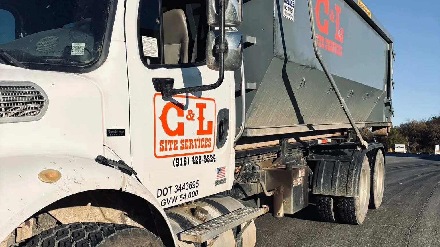 Roll-off dumpster set on a jobsite near Cookson, Oklahoma